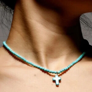 Turquoise necklace with cross pendant.